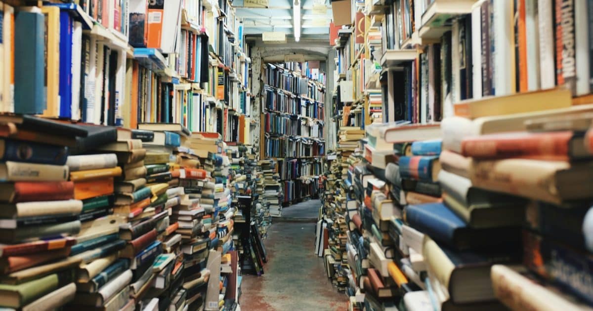 pathway in the middle of piled books